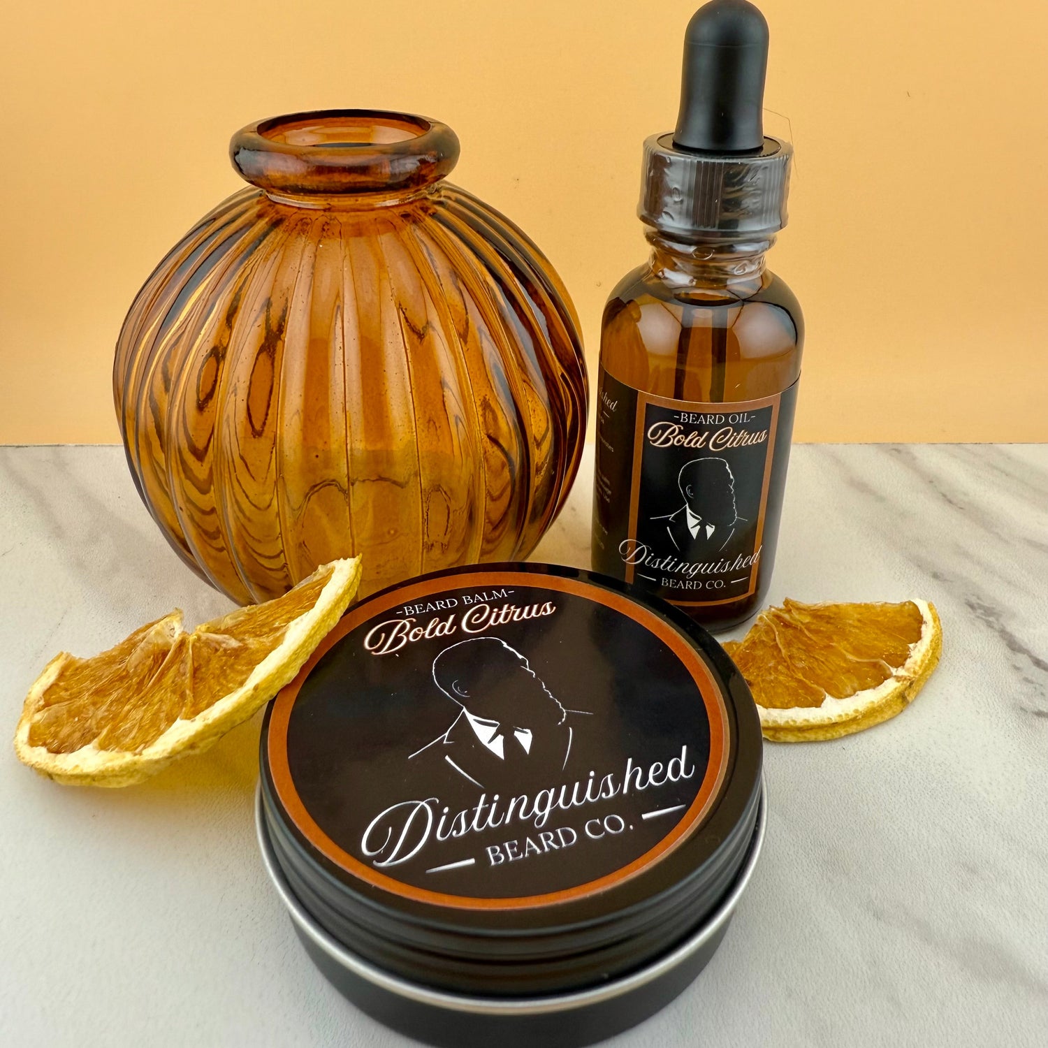 Beard care products from Distinguished Beard Co. on a marble surface with an orange background